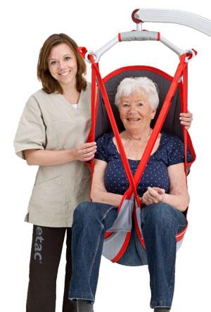 Woman in hanging sling with caregiver