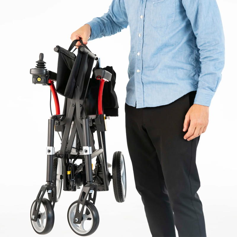 Feather Power Chair folded and held by a person using a single arm